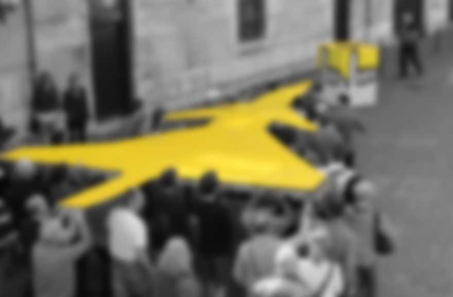 People carrying fighterjet towards a voting booth